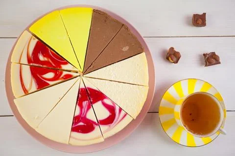 Assorted cheesecake on plate on white table Stock Photos