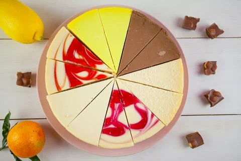 Assorted cheesecake on plate on white table Stock Photos