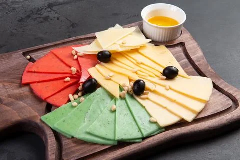 Assorted cheeses on a dark background. Stock Photos