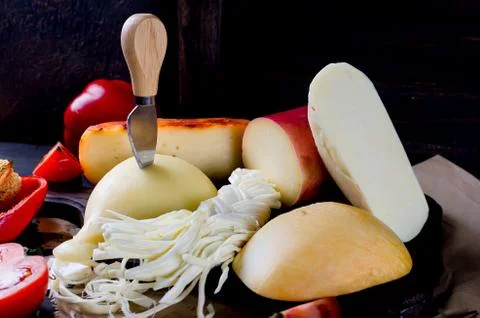 Assorted cheeses in various shapes and sizes 写真素材