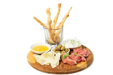 Assorted cheeses, wallnuts and other snacks Stock Photos