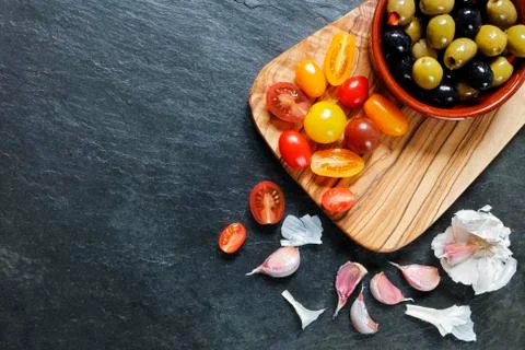 Assorted cherry tomatoes with olives and garlic Stock Photos