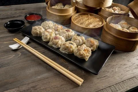 Assorted chinese dim sum dumpling on the plate with bamboo wooden basket bo.. Stock Photos