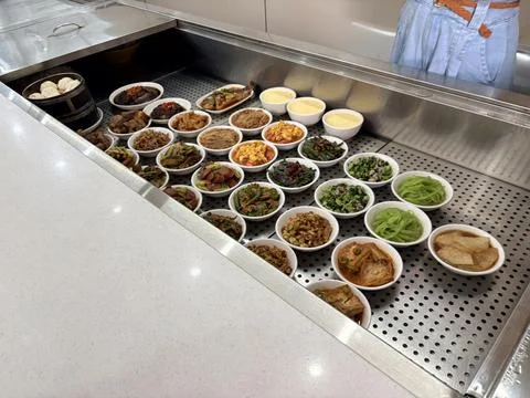 Assorted Chinese Side Dishes and Dim Sum in a Cafeteria Display Stock Photos