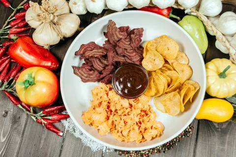 Assorted chips with sauce on a white plate Stockfoto's