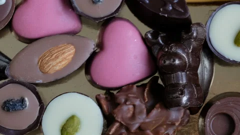 Assorted chocolate and cocoa on black background, close up. Directly above view Stock Footage 102420709