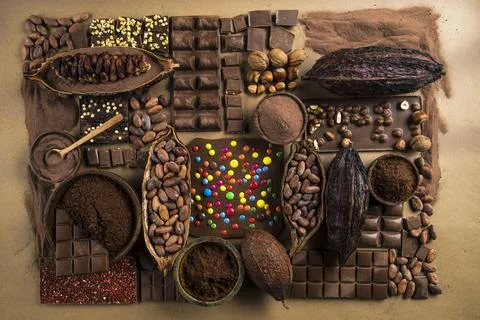 Assorted chocolate bar, candy sweet, cocoa pod, natural paper background Stock Photos