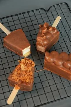 Assorted Chocolate Cheesecake Pops on Wire Rack Top View Stock Photos