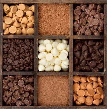 Assorted chocolate chips in a printers box Stock Photos