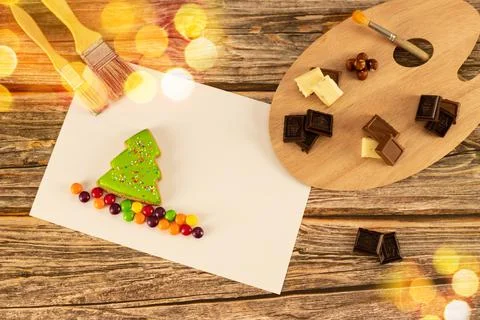 Assorted chocolates are set on an artistic palette against a warm wooden Stock Photos
