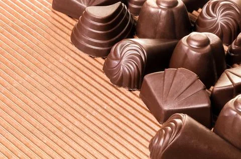 Assorted chocolates on brown Stock Photos