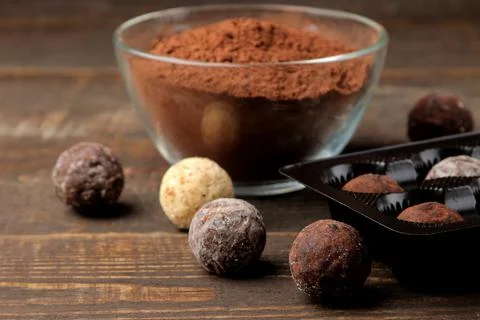 Assorted chocolates. candies of different types of chocolate on a brown woode Stock Photos