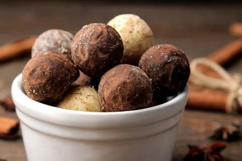 Assorted chocolates. candy balls of different types of chocolate on a brown w Stock Photos