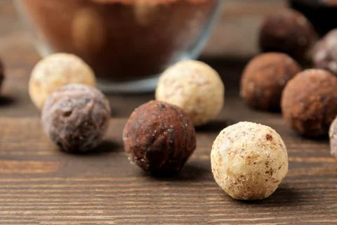 Assorted chocolates. candy balls of different types of chocolate on a brown w Stock Photos
