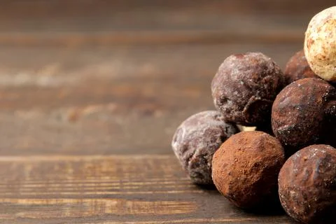 Assorted chocolates. candy balls of different types of chocolate on a brown w Stock Photos