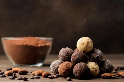 Assorted chocolates. candy balls of different types of chocolate on a brown w Stock Photos