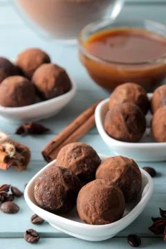 Assorted chocolates. candy balls of different types of chocolate on a blue wo Stock Photos
