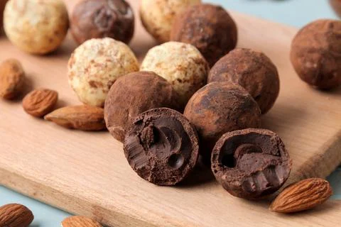 Assorted chocolates. Candy balls of different types of chocolate on a wooden Stock Photos