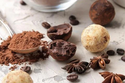 Assorted chocolates. Candy balls of different types of chocolate on a light c Stock Photos