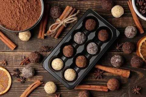 Assorted chocolates. candy balls of different types of chocolate on a brown w Stock Photos