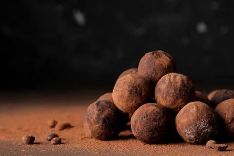 Assorted chocolates. candy balls of different types of chocolate on a dark ba Stock Photos