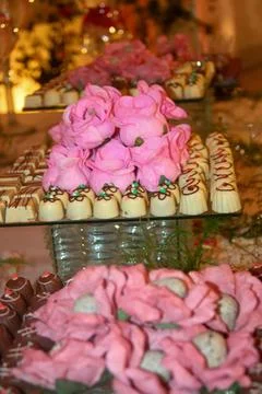 Assorted chocolates with pink roses Stock Photos