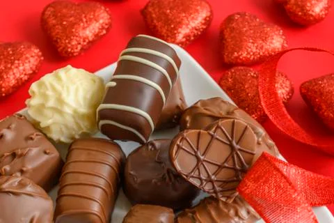 Assorted chocolates with red hearts Stock Photos