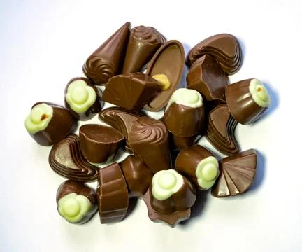 Assorted chocolates in various shapes and fillings on white background Stock Photos