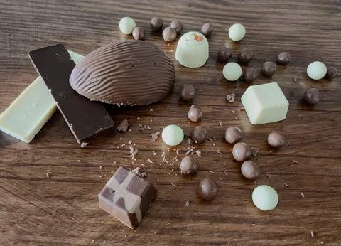 Assorted chocolates on a wooden table Stock Photos
