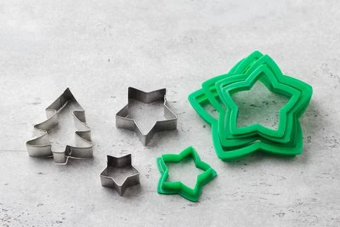 Assorted Christmas cookie cutters on grey textured background, top view Stock Photos