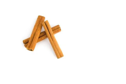 Assorted cinnamon bark pieces displayed on a white background, showcasing t.. Stock Photos