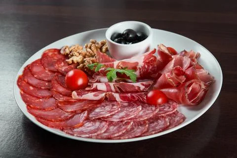 Assorted cold meat deli plate at the restaurant Stock Photos