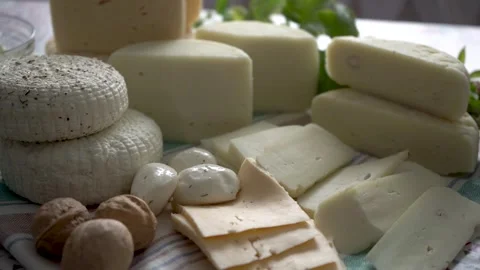 An assorted collection of Artisan Cheeses beautifully arranged on a vibrant Stock Footage 279658778