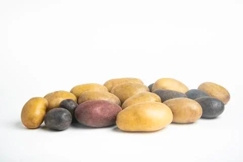 Assorted Color Potatoes On White Surface Table Stock Photos