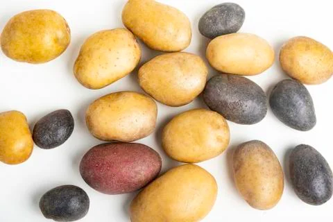 Assorted Color Potatoes On White Surface Table Stock Photos