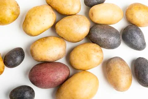 Assorted Color Potatoes On White Surface Table Stock Photos