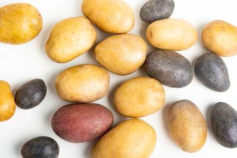 Assorted Color Potatoes On White Surface Table Stock-Fotos