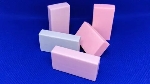Assorted Colored Erasers Arranged Against a Bright Blue Background Stock Photos