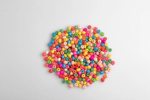 Assorted colored plastic beads on a white background. Stock Photos