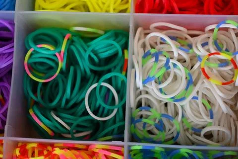 Assorted colored rubber bands in compartments Photos