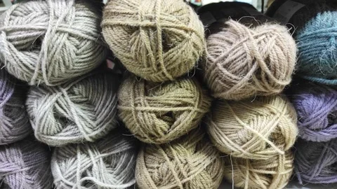 Assorted colorful balls of knitting yarn on shelves in a craft store Video stock 344041319