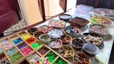 Assorted Colorful Beads and Buttons in a Craft Workshop Setting Stock Footage 339518522