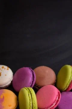 Assorted colorful macaroons on a dark background Stock Photos