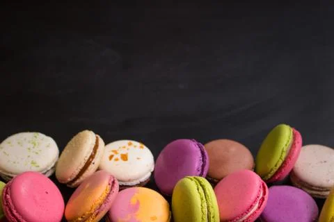 Assorted colorful macaroons on a dark background Stock Photos