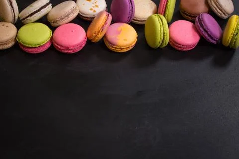 Assorted colorful macaroons on a dark background Stock Photos