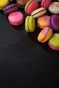 Assorted colorful macaroons on a dark background Stock Photos