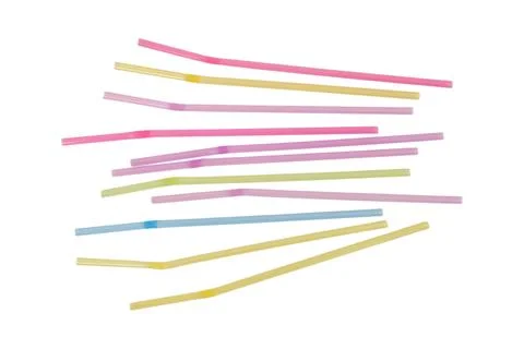 Assorted colorful plastic drinking straws scattered on white background. Di.. Fotos Stock