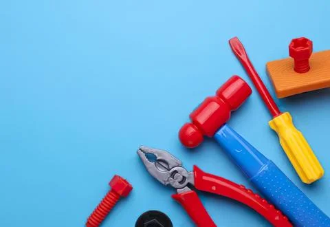 Assorted colorful plastic tools on blue background for repairs Stock Photos