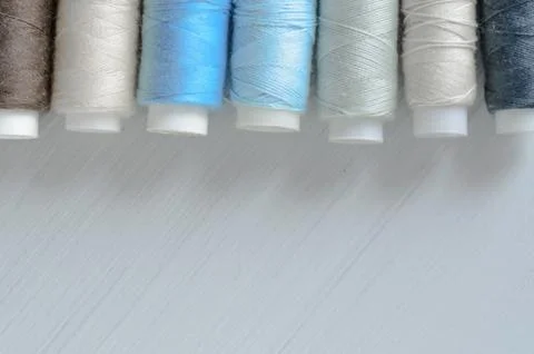 Assorted of colorful thread spools on table, needlework and tailoring concept Stock Photos