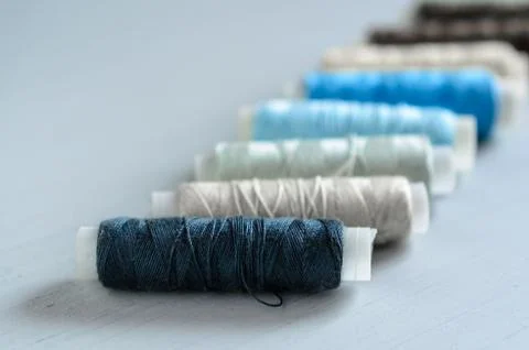 Assorted of colorful thread spools on table, needlework and tailoring concept Stock Photos